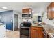 Updated kitchen showcasing stainless steel appliances, wood cabinets, granite countertops, and an open layout at 3253 S Kalispell St, Aurora, CO 80013