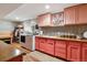 Well-appointed laundry room with modern appliances, pink cabinets, and stylish backsplash at 3253 S Kalispell St, Aurora, CO 80013