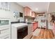 Functional laundry area featuring modern washer/dryer set and ample cabinet space with wood look flooring at 3253 S Kalispell St, Aurora, CO 80013