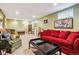 Cozy living room featuring a comfortable red sofa and green armchair, perfect for relaxation at 3253 S Kalispell St, Aurora, CO 80013