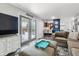 Open living room features a comfortable couch, dark wood floors and updated gray paint at 3253 S Kalispell St, Aurora, CO 80013