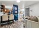 Updated living room with breakfast bar, refinished floors, and adjacent dining space at 3253 S Kalispell St, Aurora, CO 80013