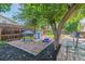 Backyard play area with a playhouse and picnic table under a shade tree, perfect for ' entertainment at 3253 S Kalispell St, Aurora, CO 80013