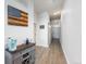Bright entry hall with wood-look floors and a built-in storage cabinet at 7240 W Custer Ave # 205, Lakewood, CO 80226