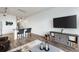 Open living area with hardwood floors and a modern media console at 7240 W Custer Ave # 205, Lakewood, CO 80226