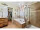 Bathroom showcasing a bathtub, stand up shower, and large sliding door to closet at 10041 Dillon Cir, Commerce City, CO 80022
