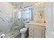 Modern bathroom with a glass-enclosed shower, marble countertops, and contemporary fixtures at 10041 Dillon Cir, Commerce City, CO 80022