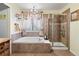 Bright bathroom with a luxurious soaking tub and a separate shower, accented by elegant curtains and tile work at 10041 Dillon Cir, Commerce City, CO 80022