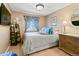 Cozy bedroom featuring soft blue accents, natural light, and classic wood furniture at 10041 Dillon Cir, Commerce City, CO 80022