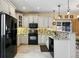 Bright kitchen with updated black appliances, tile backsplash, and ample storage space at 10041 Dillon Cir, Commerce City, CO 80022