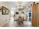 Eat-in kitchen features elegant chandelier, tile floors, breakfast nook, and access to the backyard at 10041 Dillon Cir, Commerce City, CO 80022