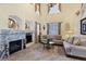 Bright living room boasts a stone fireplace, tall ceilings, lots of light, comfortable furniture, and an open design at 10041 Dillon Cir, Commerce City, CO 80022