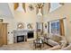 Open living room with fireplace, stone surround, high ceilings, abundant natural light, and comfortable furnishings at 10041 Dillon Cir, Commerce City, CO 80022