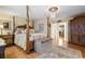 Luxurious primary bedroom with hardwood floors, elegant chandelier, and a four-poster bed at 10041 Dillon Cir, Commerce City, CO 80022