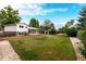 Expansive backyard with lush green grass and a well-maintained perimeter at 1011 Yeager Dr, Longmont, CO 80501