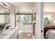 Modern bathroom with sleek vanity, black framed glass shower door, and marble style tile at 1011 Yeager Dr, Longmont, CO 80501