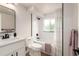 Bright bathroom featuring a sleek vanity, black fixtures, and a shower with a tub at 1011 Yeager Dr, Longmont, CO 80501