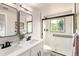 Contemporary bathroom featuring a double vanity, sleek mirrors, and a luxurious shower at 1011 Yeager Dr, Longmont, CO 80501
