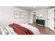 Stylish bedroom showcasing modern decor, wood floors, and an ensuite bathroom at 1011 Yeager Dr, Longmont, CO 80501