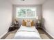 Cozy bedroom with a comfortable bed, a large window, and neutral decor at 1011 Yeager Dr, Longmont, CO 80501