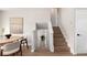 Open hallway with hardwood stairs, a round table with four chairs, and natural light streaming in at 1011 Yeager Dr, Longmont, CO 80501