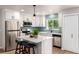 Contemporary kitchen with white cabinetry, a functional island with seating, and modern stainless appliances at 1011 Yeager Dr, Longmont, CO 80501