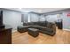 Finished basement with large sectional couch and laminate wood flooring at 8728 E 25Th Dr, Denver, CO 80238