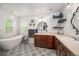 Bright bathroom featuring double vanity, soaking tub, and decorative tile flooring at 8728 E 25Th Dr, Denver, CO 80238
