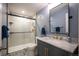 Modern bathroom with frameless glass shower, marble vanity, and stylish tile flooring at 8728 E 25Th Dr, Denver, CO 80238