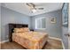 Bedroom with orange bedspread, laminate wood flooring and basement window at 8728 E 25Th Dr, Denver, CO 80238