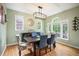 Elegant dining room with hardwood floors, large windows, modern chandelier, and stylish furnishings at 8728 E 25Th Dr, Denver, CO 80238