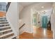 Bright entryway with wood floors, decorative tile and stairs, and a teal front door at 8728 E 25Th Dr, Denver, CO 80238
