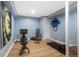 Basement exercise room with equipment and light-toned wood flooring at 8728 E 25Th Dr, Denver, CO 80238