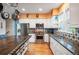 Well-equipped kitchen with stainless steel appliances, granite countertops, and custom backsplash at 8728 E 25Th Dr, Denver, CO 80238