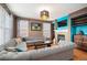 Cozy living room with hardwood floors, a fireplace, comfortable seating, and stylish decor at 8728 E 25Th Dr, Denver, CO 80238