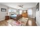 Spacious main bedroom with wood floors, floral rug, and natural light at 8728 E 25Th Dr, Denver, CO 80238