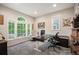 Bright home office with a large window, modern desk setup, and comfortable seating area at 8728 E 25Th Dr, Denver, CO 80238