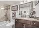 Stylish bathroom with tiled shower, granite countertop vanity, and decorative mirror at 1551 Larimer St # 2704, Denver, CO 80202