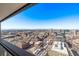 Stunning city view from a high-rise balcony showing city buildings and snow-capped mountain range at 1551 Larimer St # 2704, Denver, CO 80202