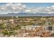 Expansive city view with mountains, an amusement park and the Denver skyline on a partly cloudy day at 1551 Larimer St # 2704, Denver, CO 80202