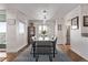 Dining area with modern lighting, neutral decor, and view into the kitchen at 1551 Larimer St # 2704, Denver, CO 80202