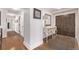 Hallway features hardwood floors, a decorative table, a lamp, art, and closet with panel doors at 1551 Larimer St # 2704, Denver, CO 80202