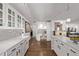 Elegant kitchen with white cabinetry, marble countertops, and tiled backsplash with hardwood floors at 1551 Larimer St # 2704, Denver, CO 80202