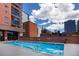 Rooftop pool with city views and comfortable lounging area at 1551 Larimer St # 2704, Denver, CO 80202