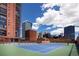 Tennis court with city views in a brick walled area on a sunny day at 1551 Larimer St # 2704, Denver, CO 80202