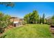 Large backyard with a hot tub and pergola on a green lawn at 22227 E Hinsdale Ave, Aurora, CO 80016