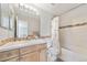 Bathroom featuring custom tile work, bathtub, shower, and wooden vanity at 22227 E Hinsdale Ave, Aurora, CO 80016