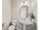 Powder room showcasing pedestal sink, modern fixtures, and neutral decor at 22227 E Hinsdale Ave, Aurora, CO 80016