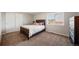 A comfy bedroom features a large window providing natural light and ample space at 22227 E Hinsdale Ave, Aurora, CO 80016