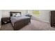 Bedroom features large bed, natural light from large window, and neutral carpet at 22227 E Hinsdale Ave, Aurora, CO 80016